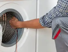 Dryer repair technician diagnosing and servicing a clothes dryer in Jacksonville, FL