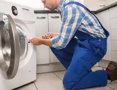 Washing machine repair technician servicing a front-load washer in Jacksonville, FL